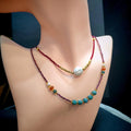 Double layer choker necklace with purple garnet, blue-green jadeite beads, freshwater pearl, and red spinel accents