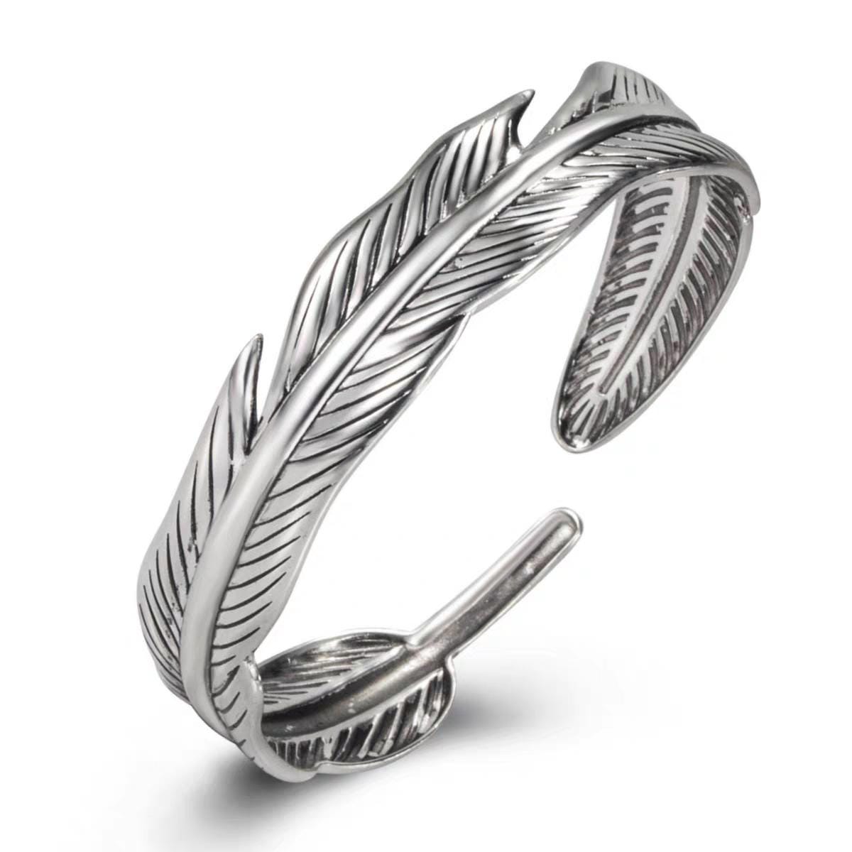 Silver feather-shaped bracelet on a white background