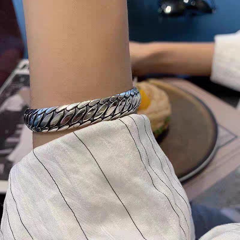 Silver bracelet on a wrist with a blurred background