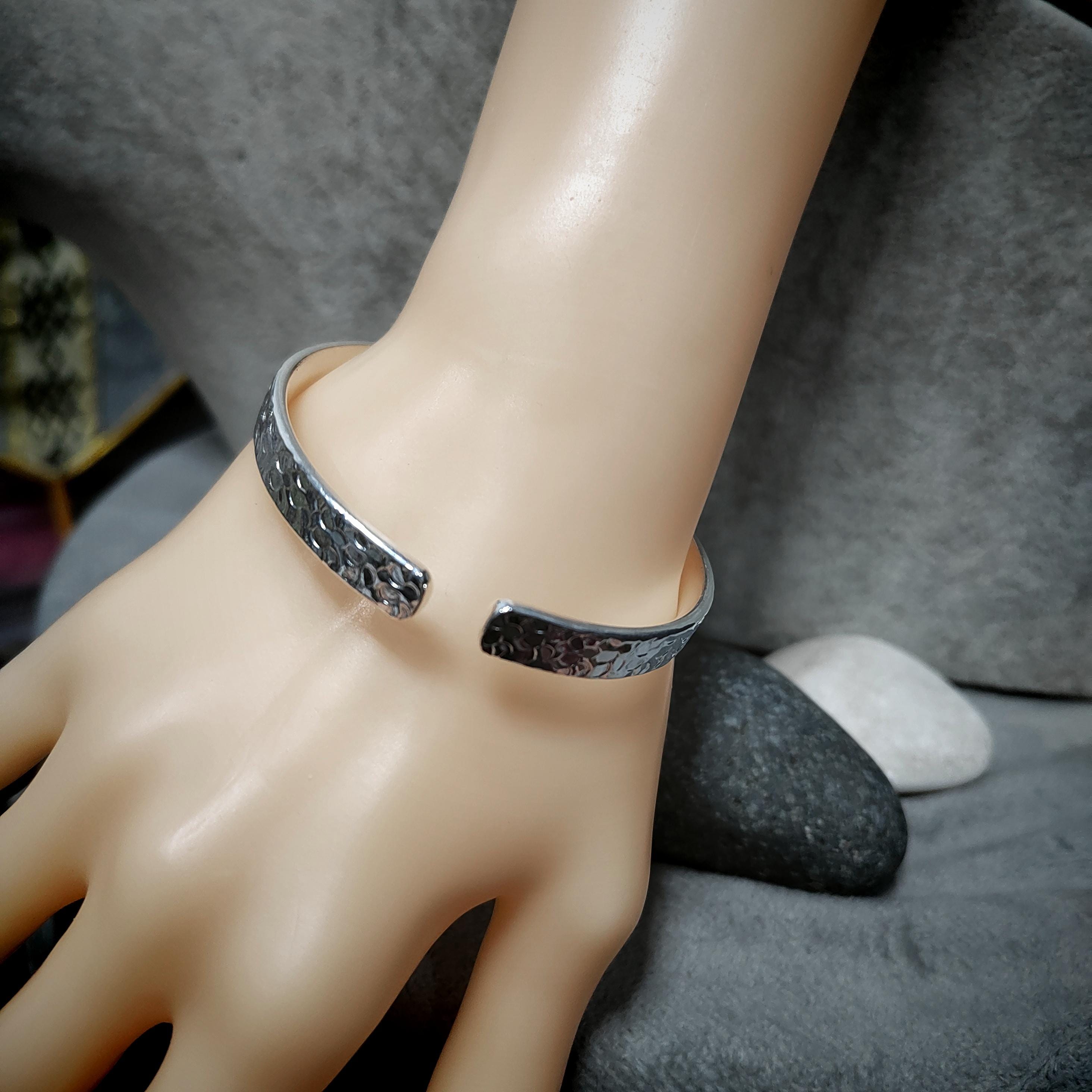 Bracelet on a mannequin hand with a gray background