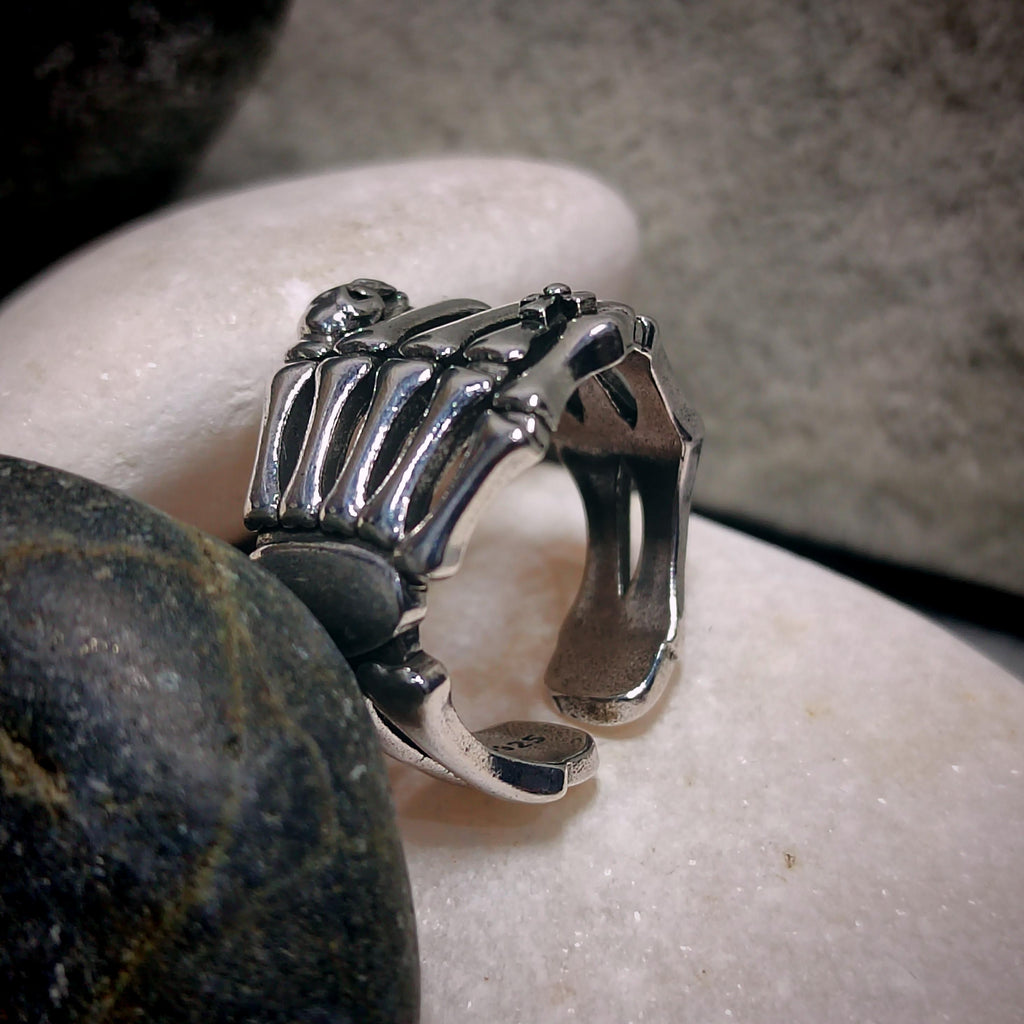 Silver ring with a unique design on a stone surface