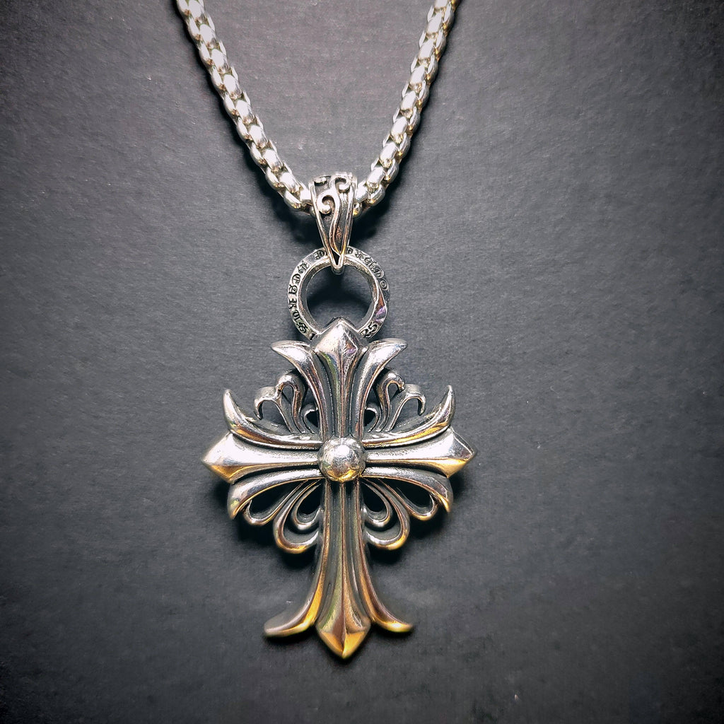 Silver cross pendant necklace on a dark background