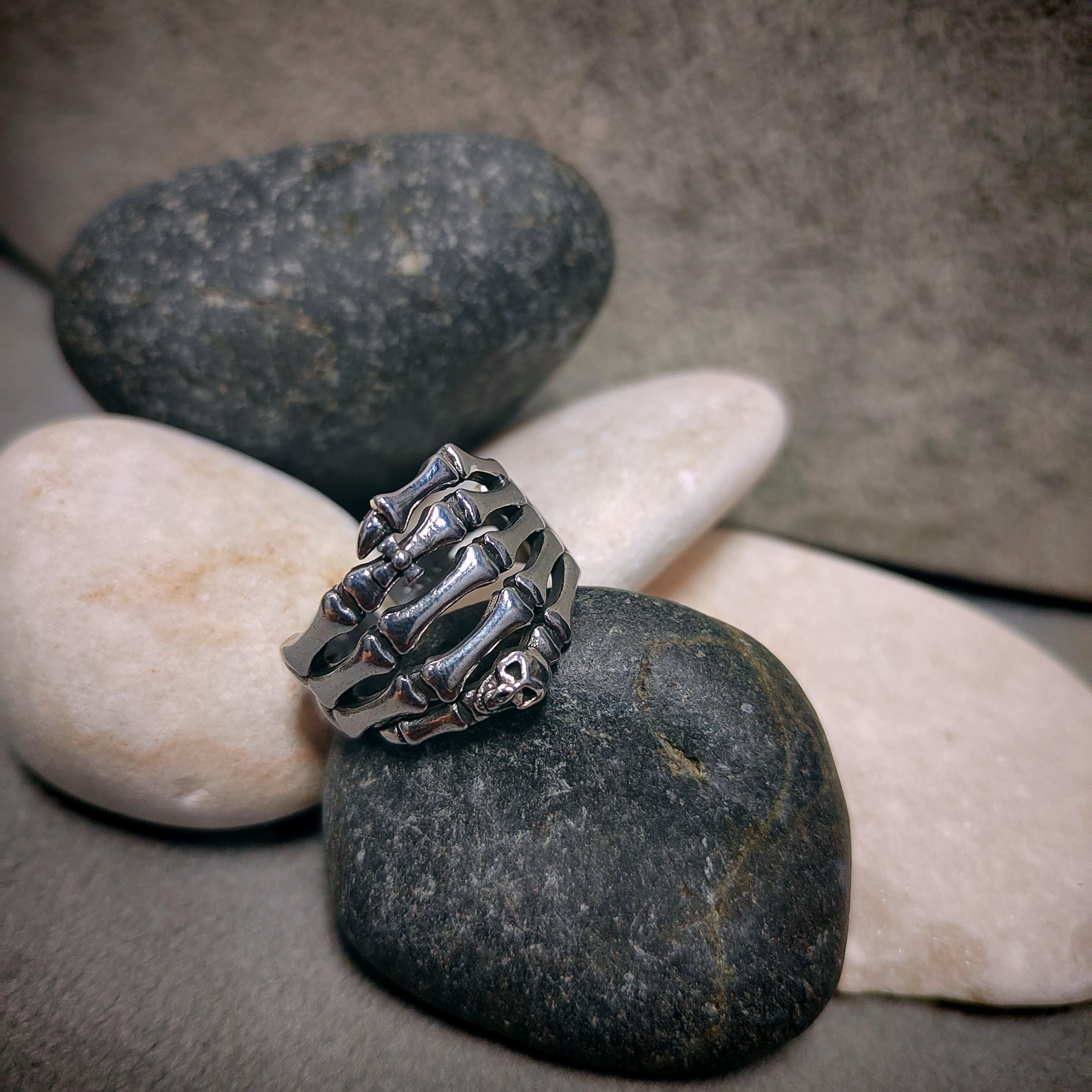 Silver ring with a unique design on a stone surface