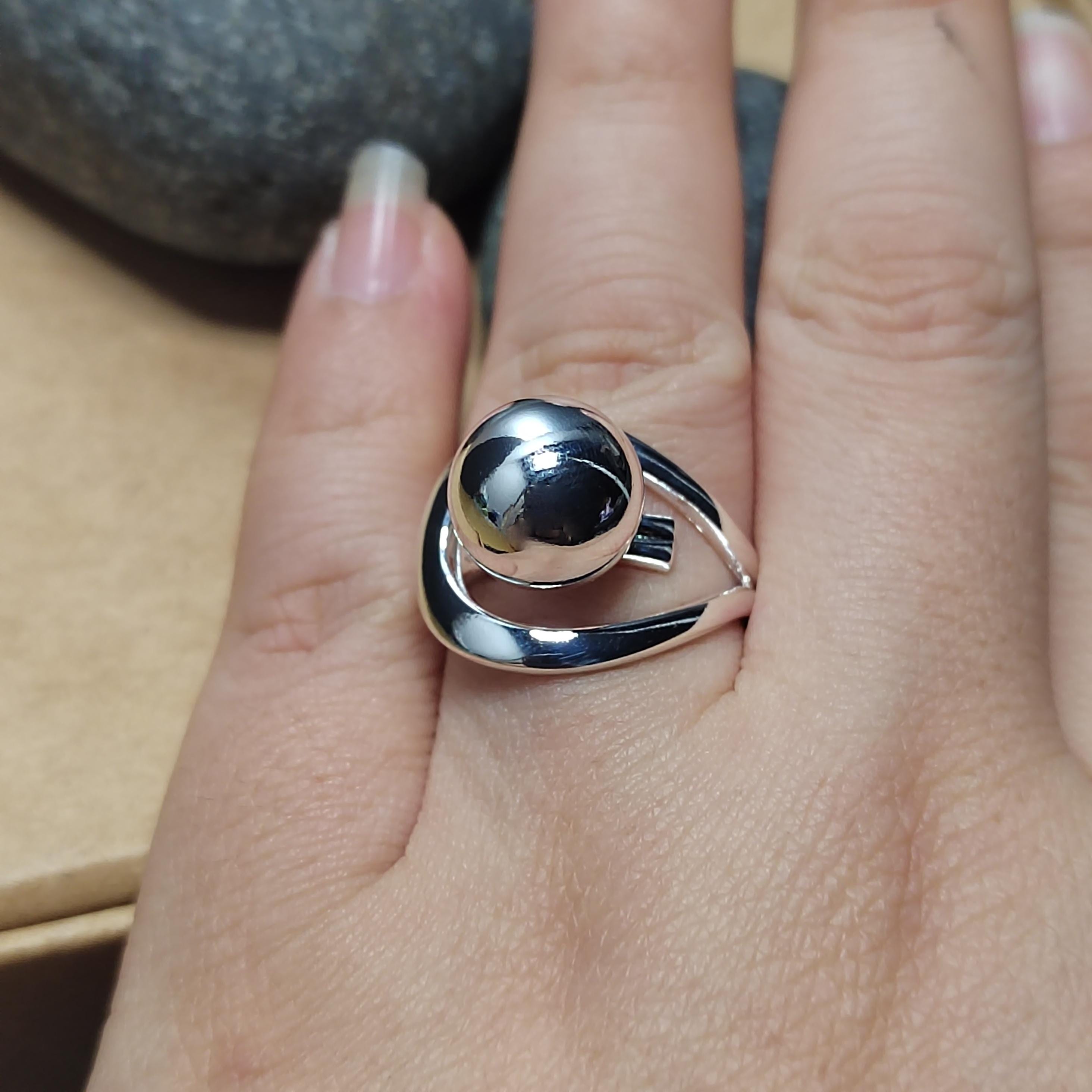 Silver ring on a person's finger with a blurred background