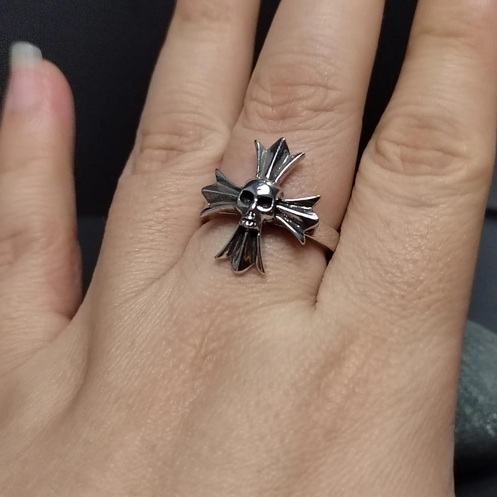 Silver ring with a star design on a person's finger