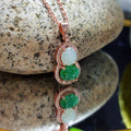 Exquisite Burmese jadeite pendant with white and green stones, rose gold plated silver, and zirconia accents on chain.