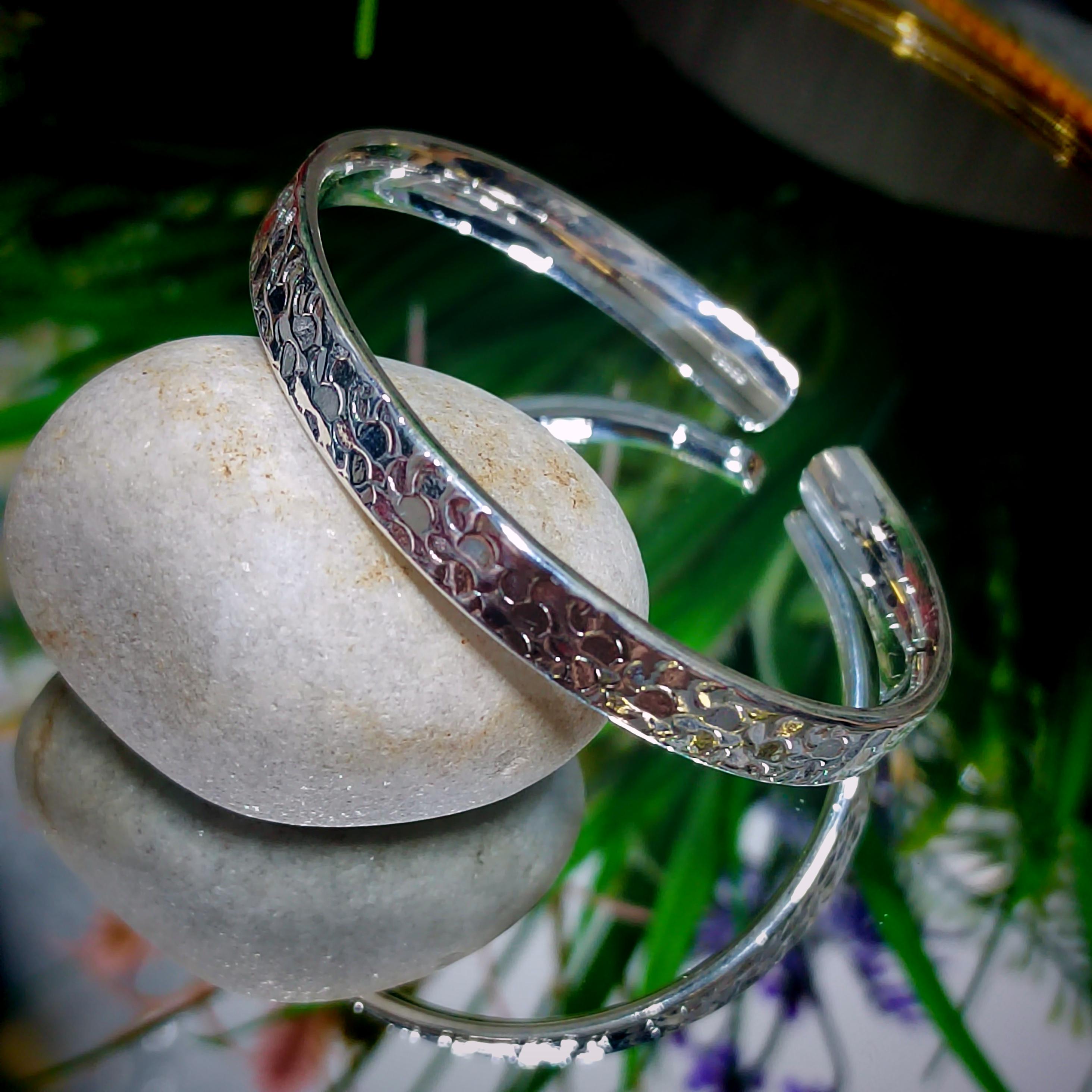 Silver bracelet on a stone with a natural background