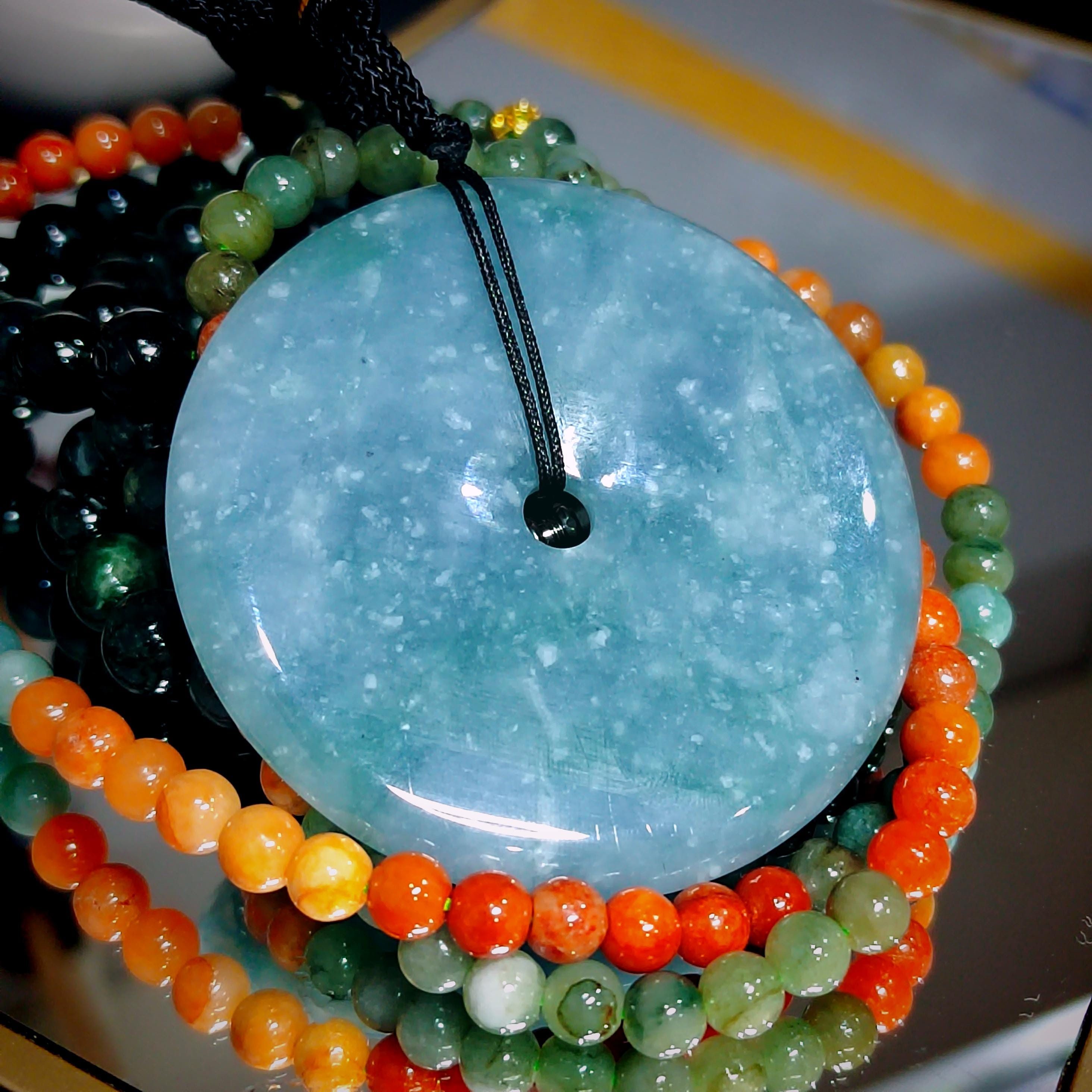 Colorful beaded necklace with a large turquoise stone pendant on a blurred background