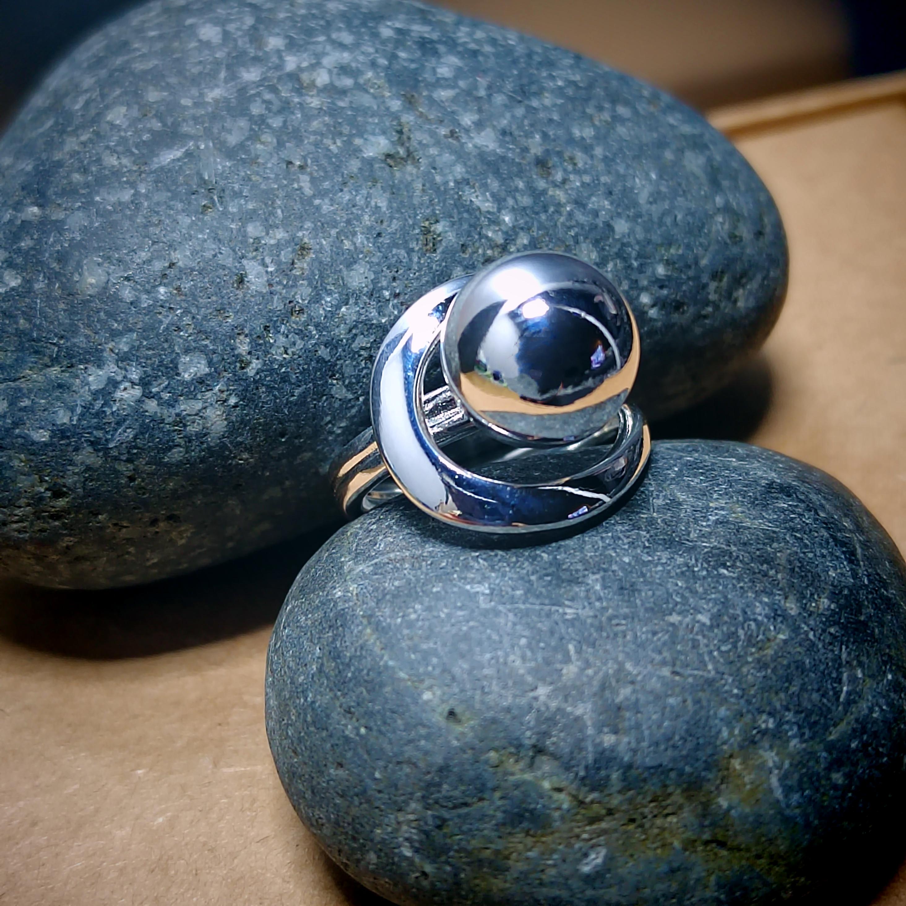 Silver ring with a reflective surface on a blue stone