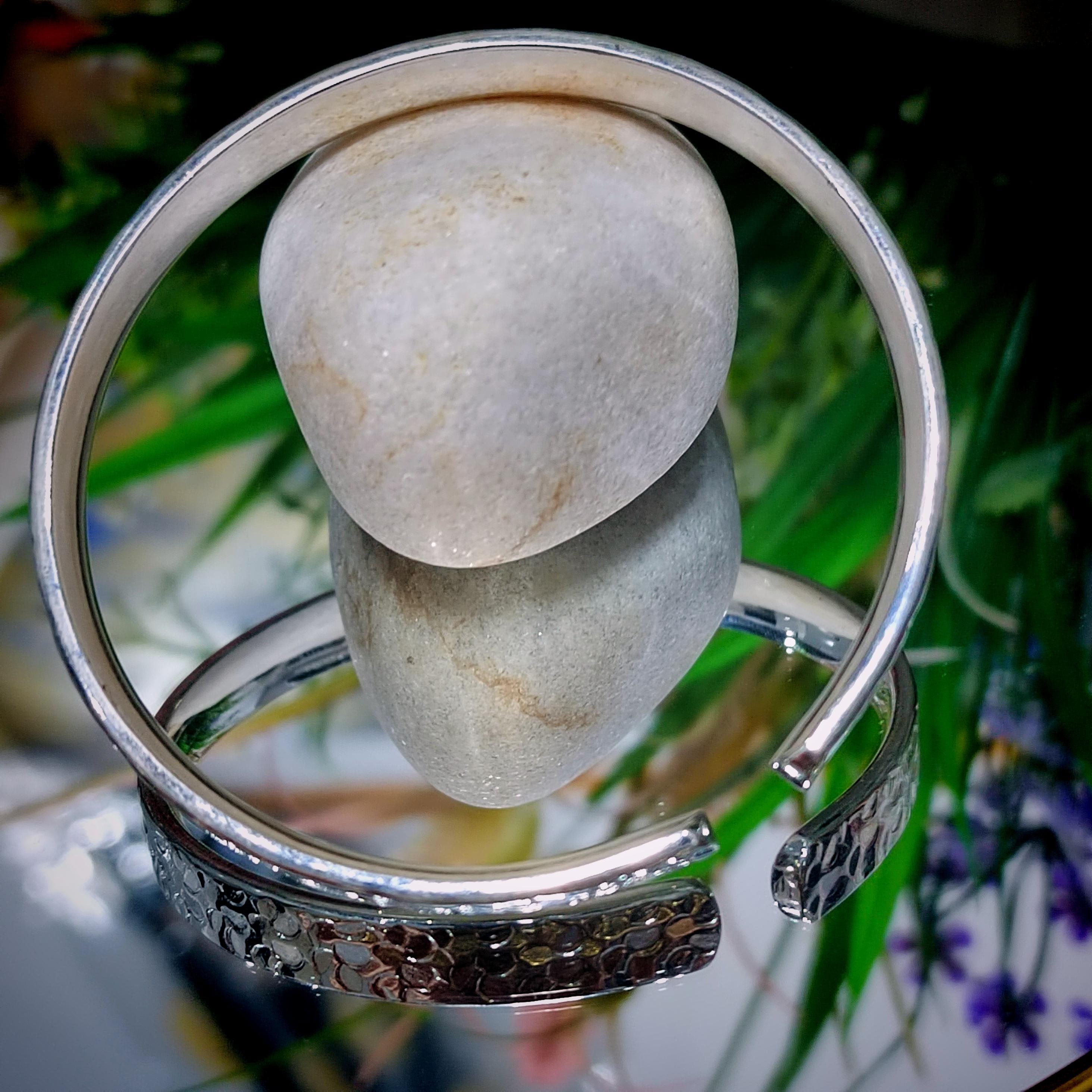 Silver bracelet with a stone on a natural background