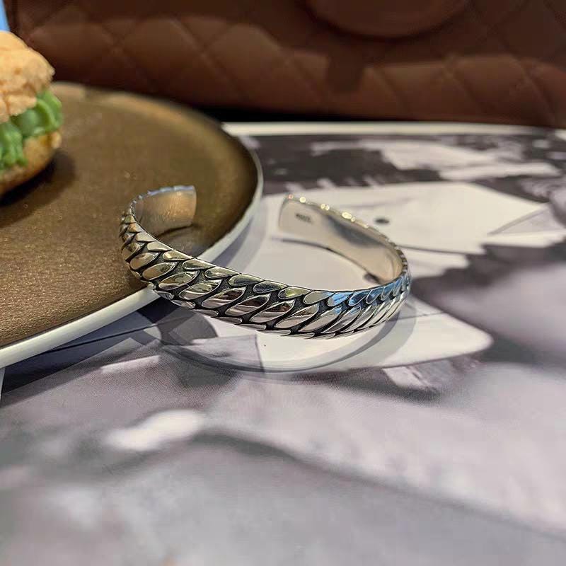 Silver bracelet on a magazine with a blurred background