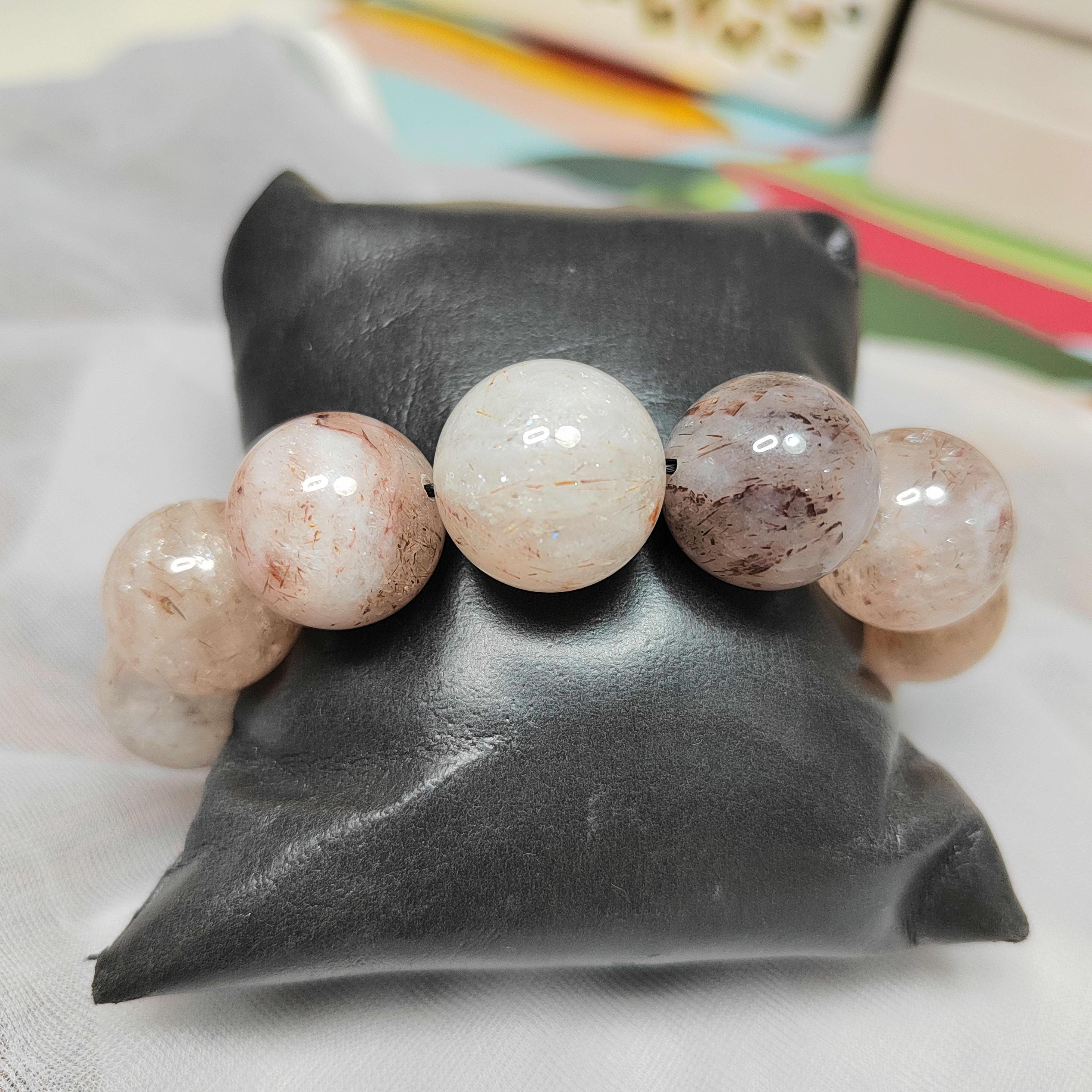 Bracelet with marbled beads on a dark gray cushion