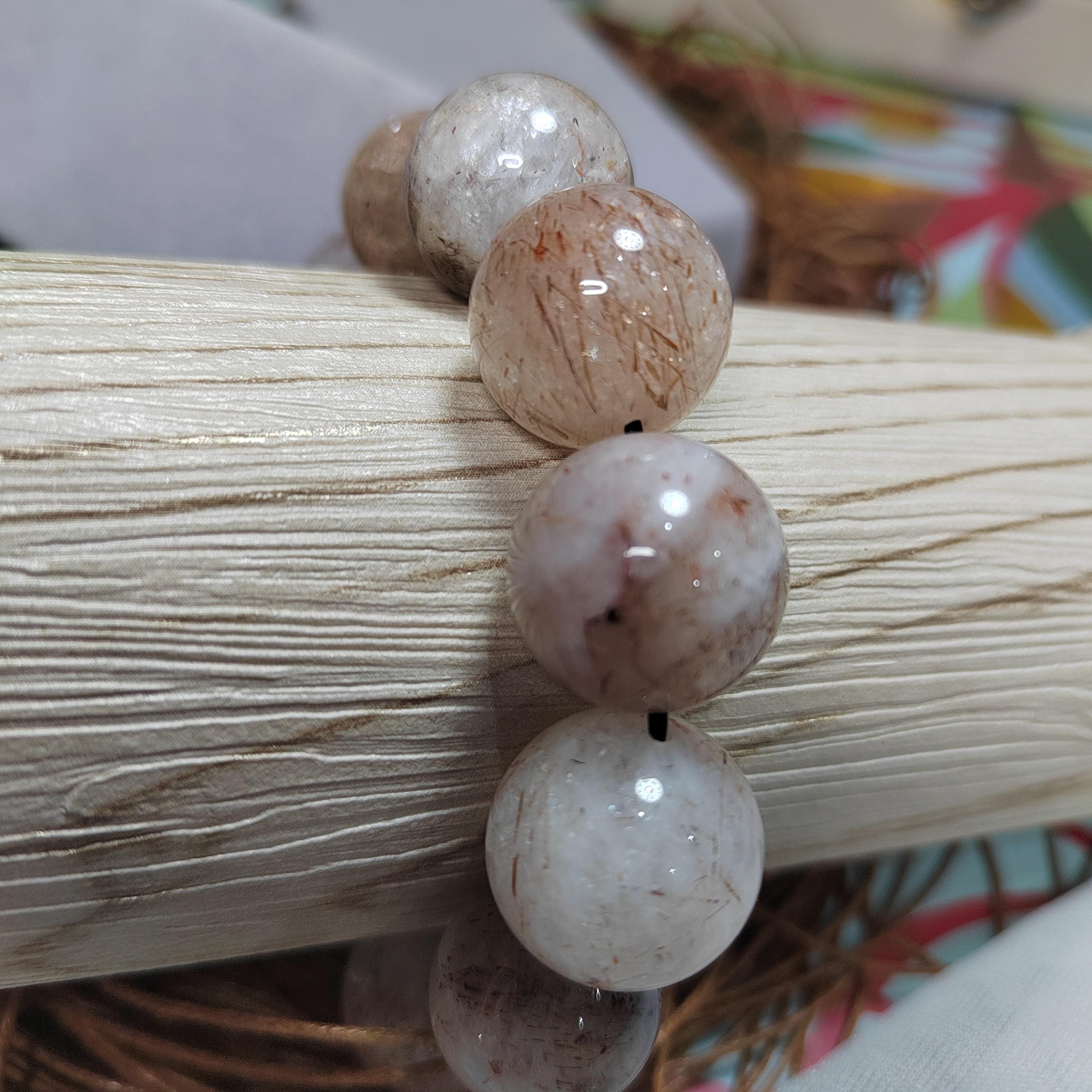 Close-up of a bracelet with beige beads on a textured surface