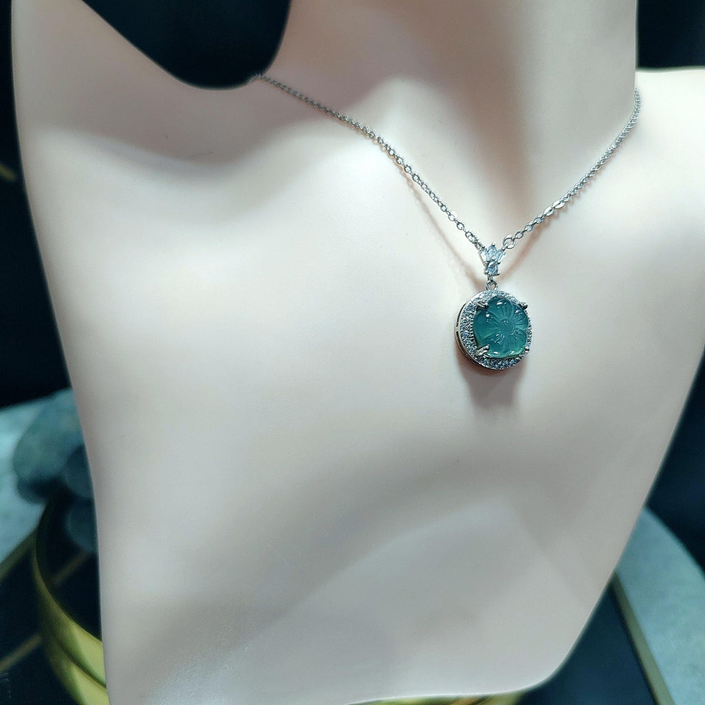 Necklace with a green pendant on a mannequin