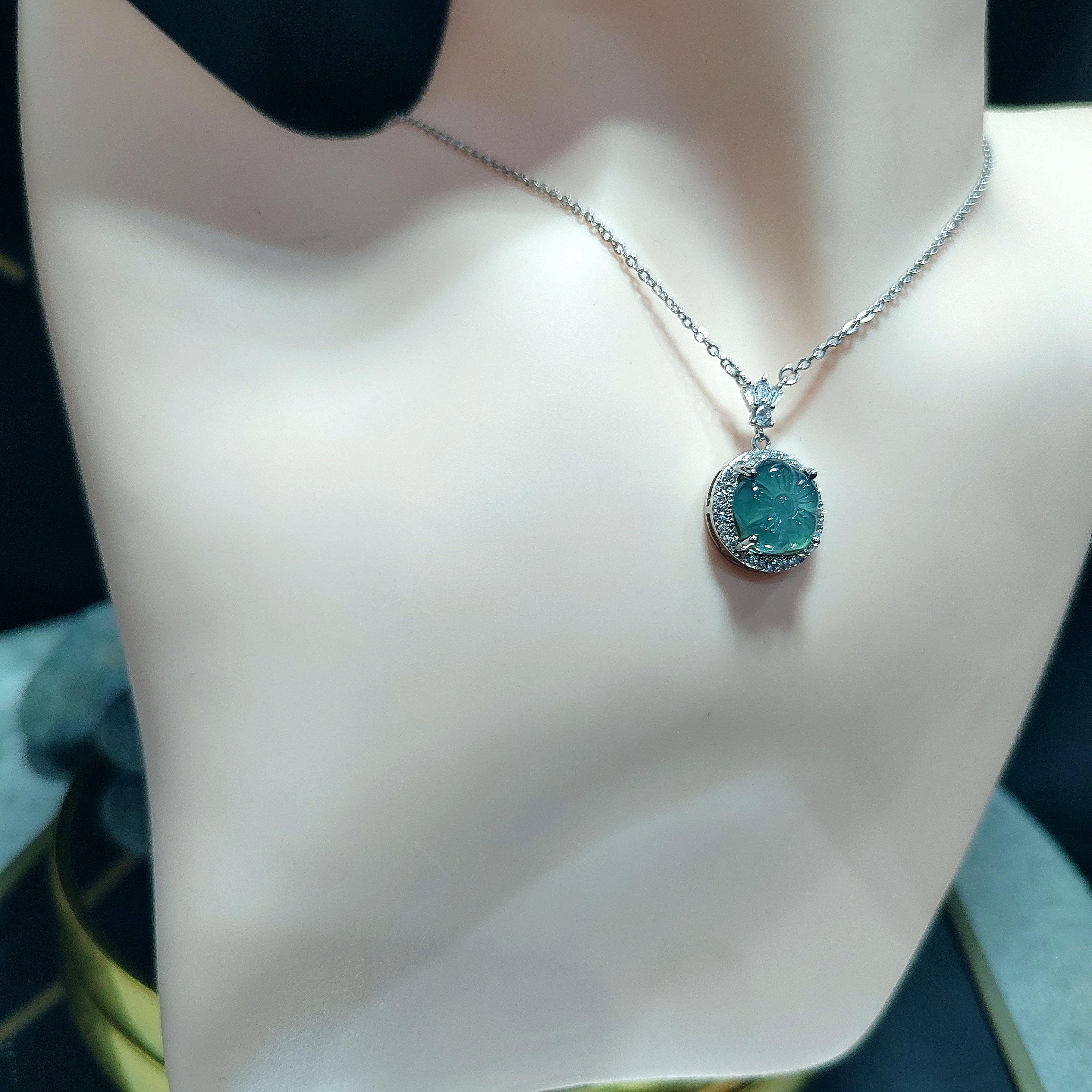 Necklace with a green pendant on a mannequin