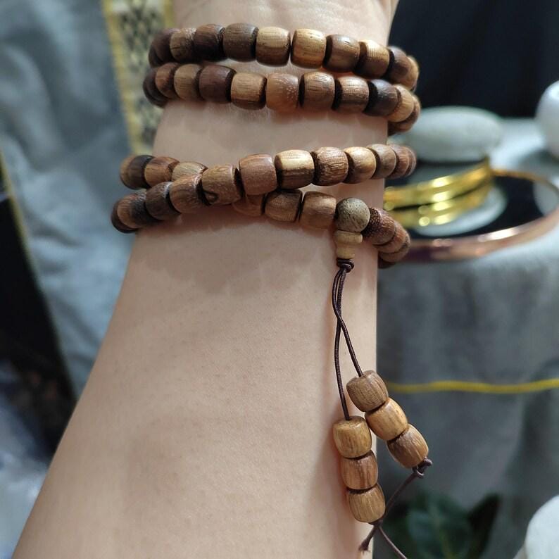 Wooden beaded bracelet on a wrist with a blurred background