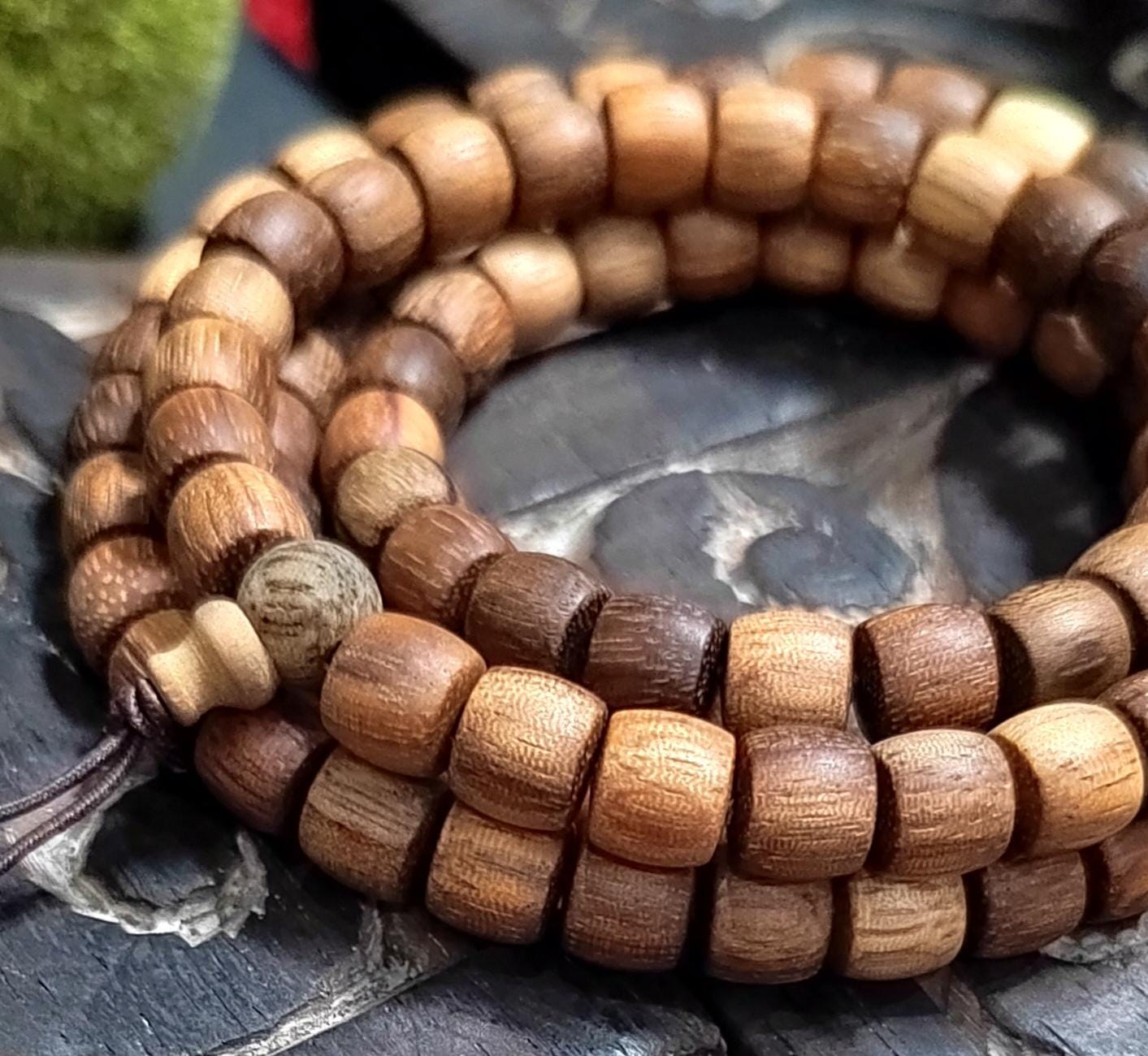 Wooden beaded bracelet on a textured surface