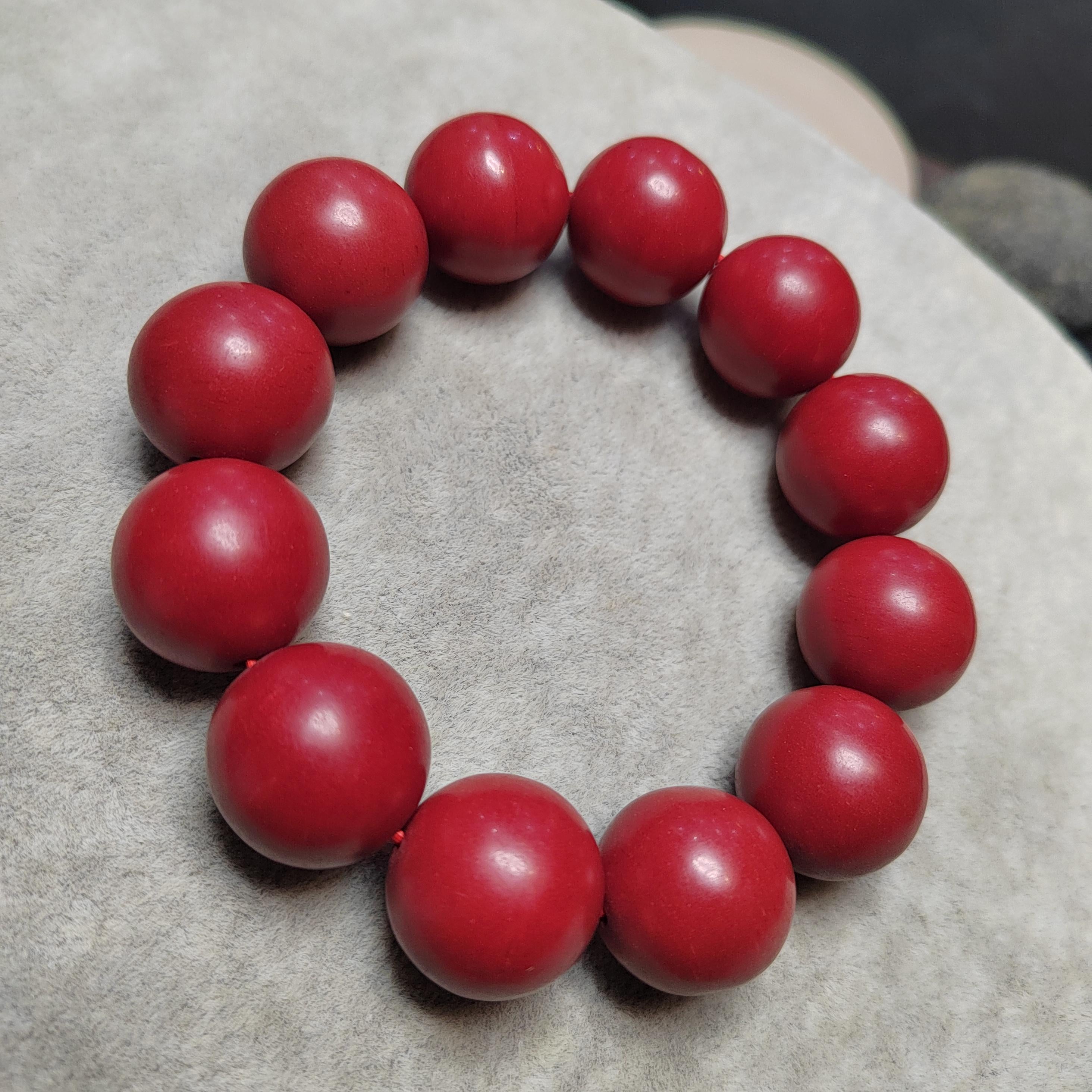 Red beaded bracelet on a textured surface