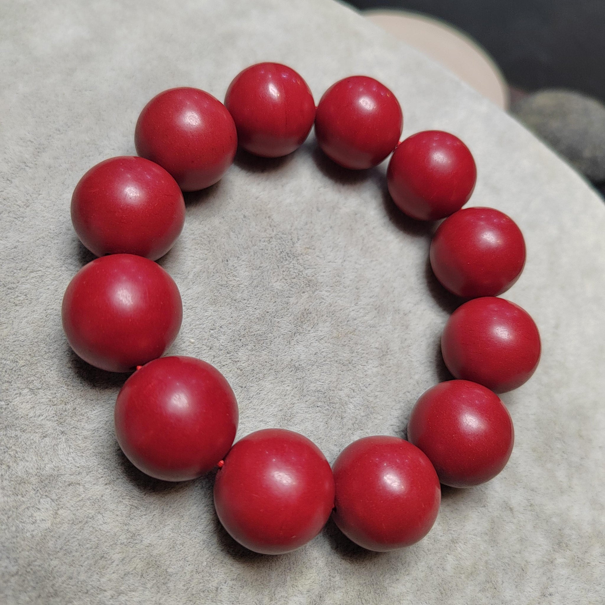 Red beaded bracelet on a textured surface