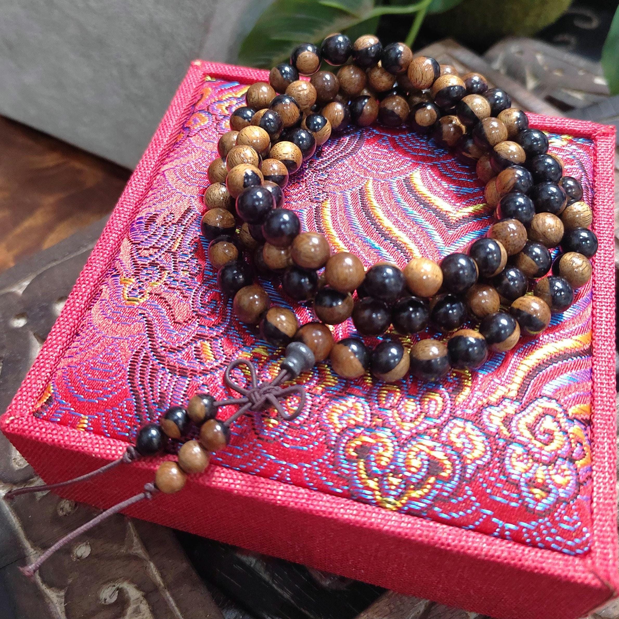 Wooden beaded necklace on a colorful fabric box