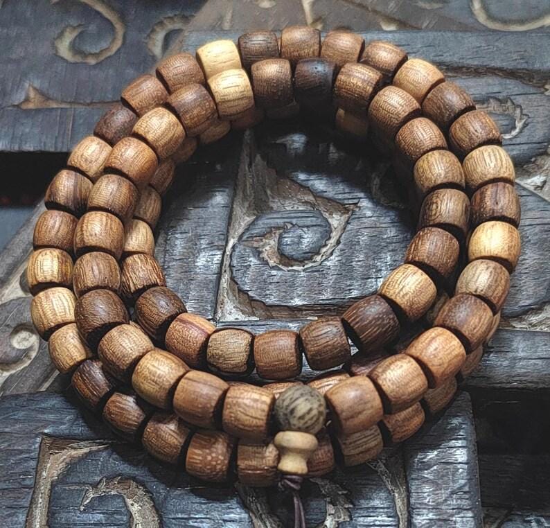 Wooden beaded bracelet on a textured wooden surface