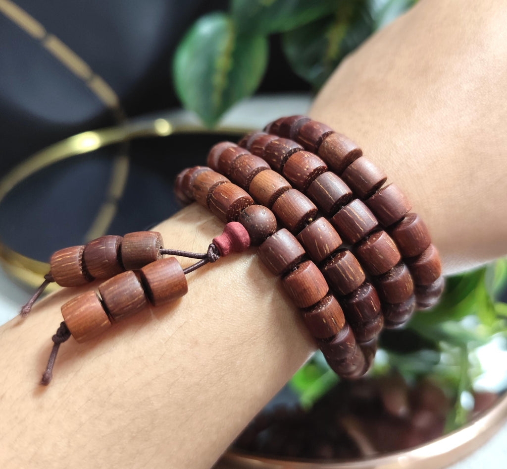 Wooden beaded bracelet on a wrist with a blurred background