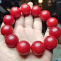 Red round beads on a hand with a blurred background