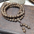 Wooden beaded necklace on a wooden surface