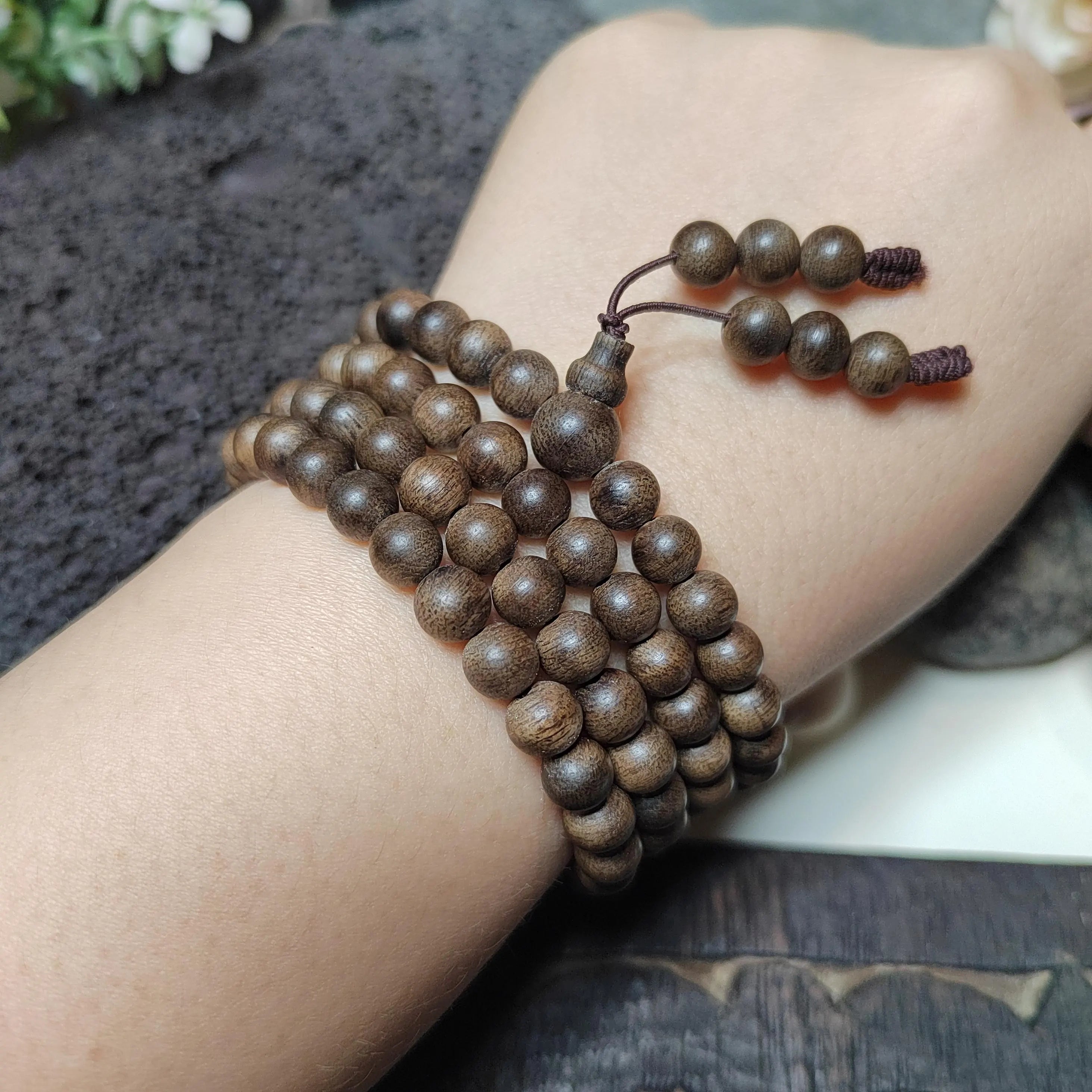 Wooden beaded bracelet on a wrist with a blurred background