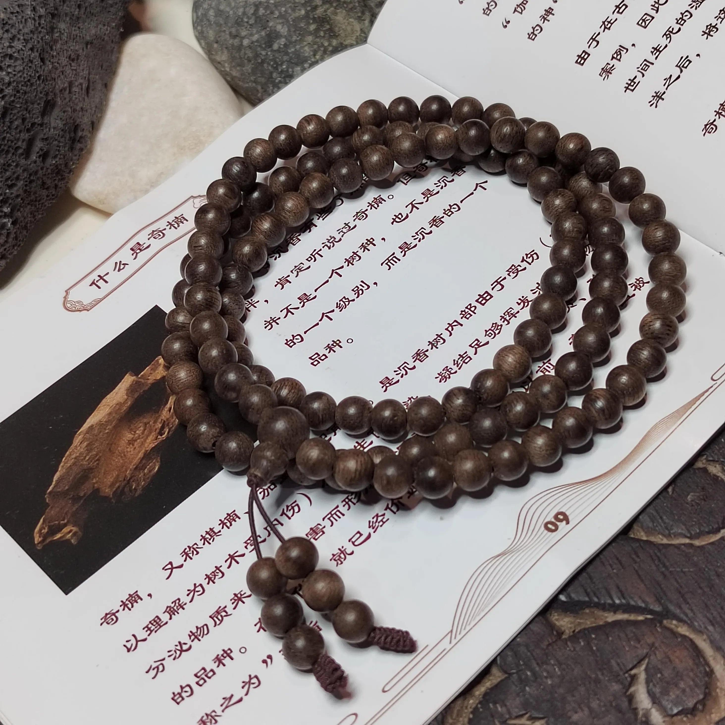 Wooden beaded necklace on a textured surface with text