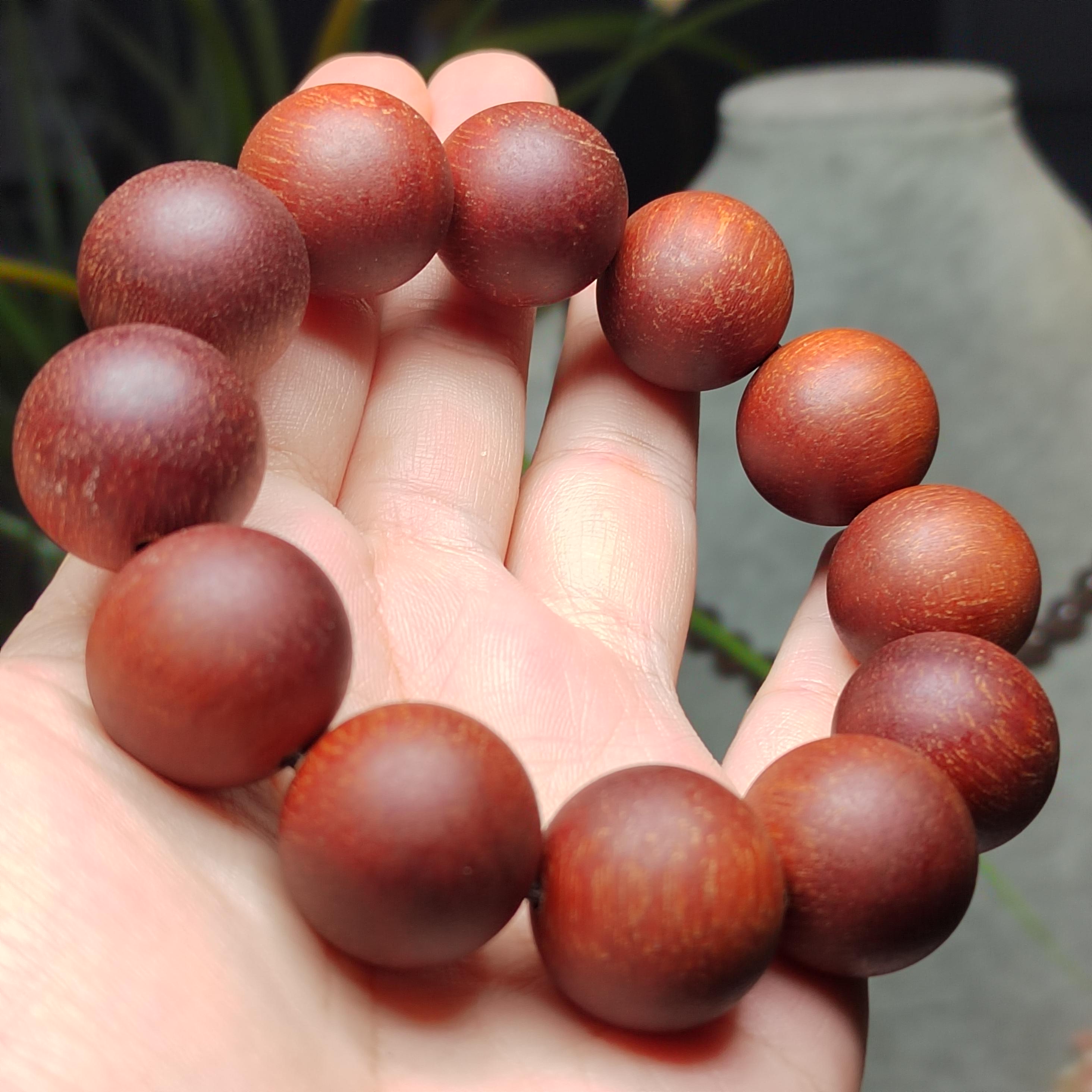 Wooden beads on a hand with a blurred background