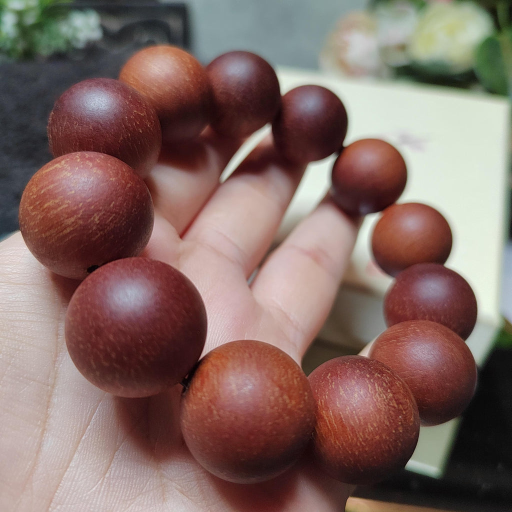 Wooden beads on a hand with a blurred background