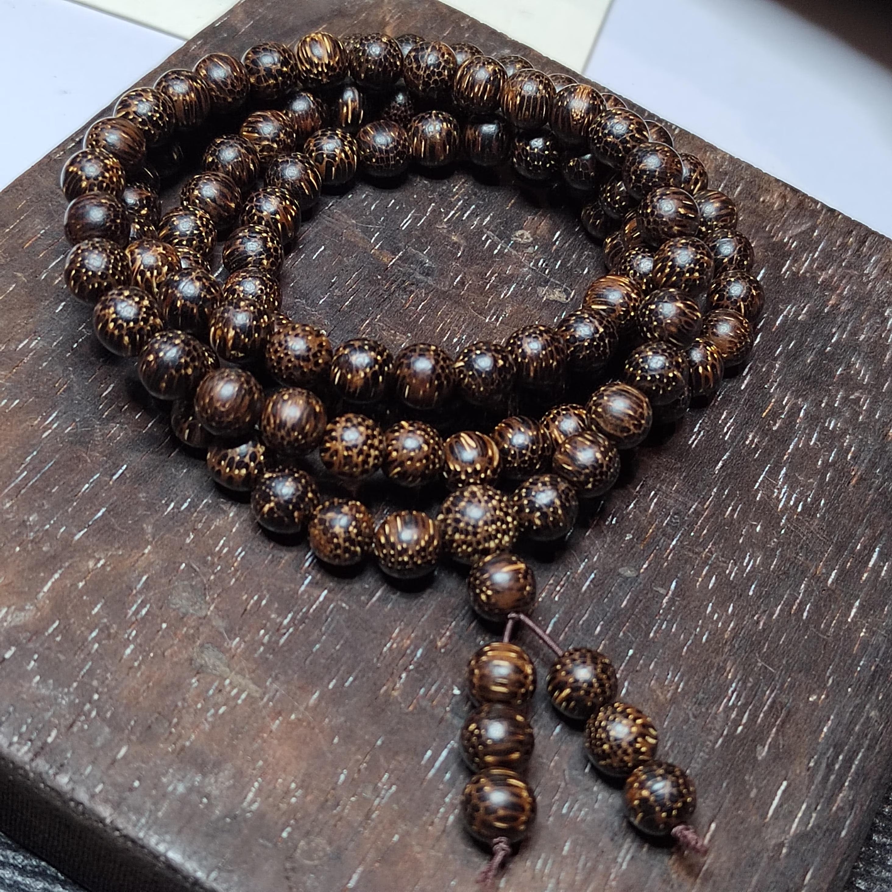 Wooden prayer beads on a wooden surface