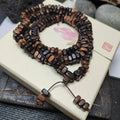 Wooden beaded bracelet on a decorative box with floral design