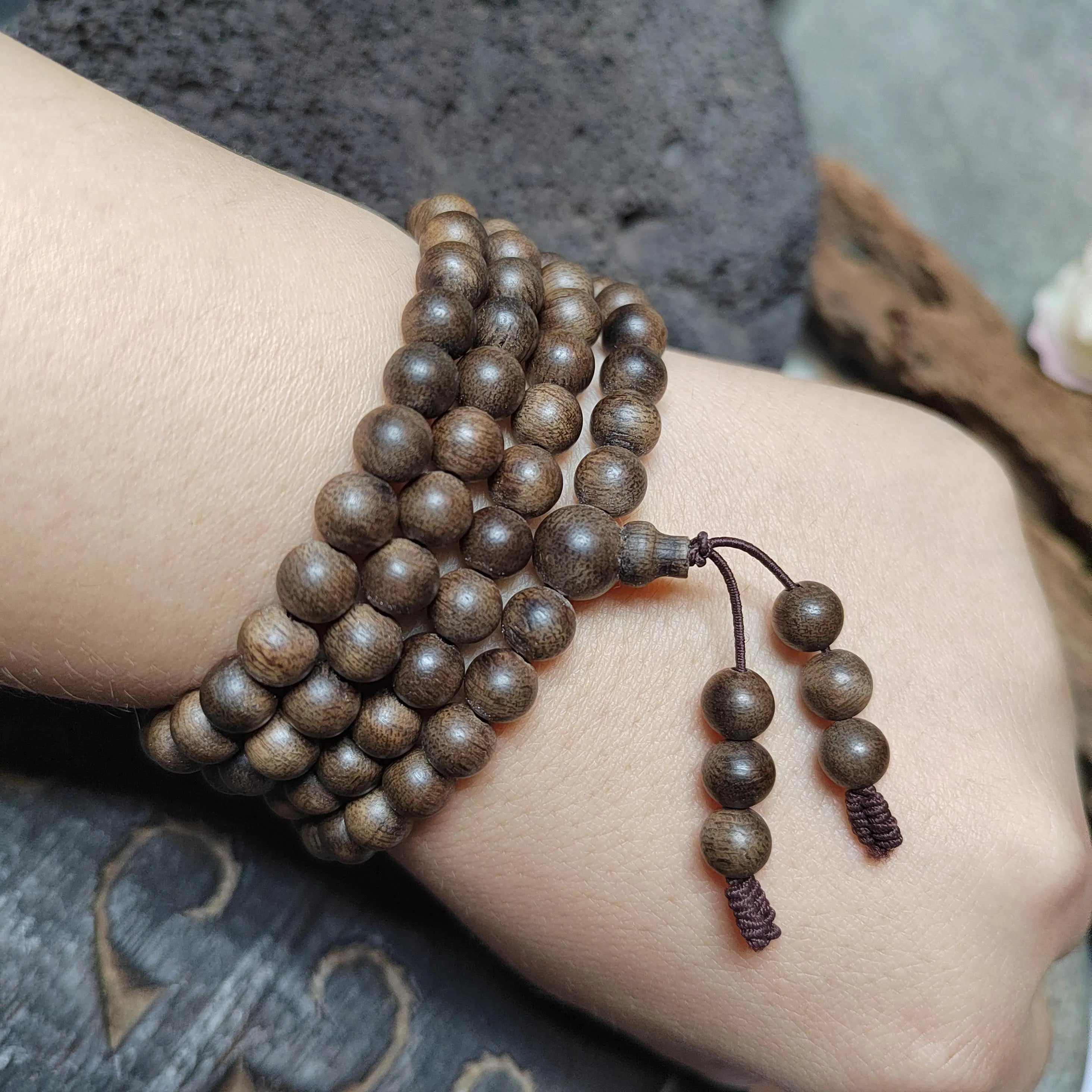 Wooden beaded bracelet on a wrist with a blurred background