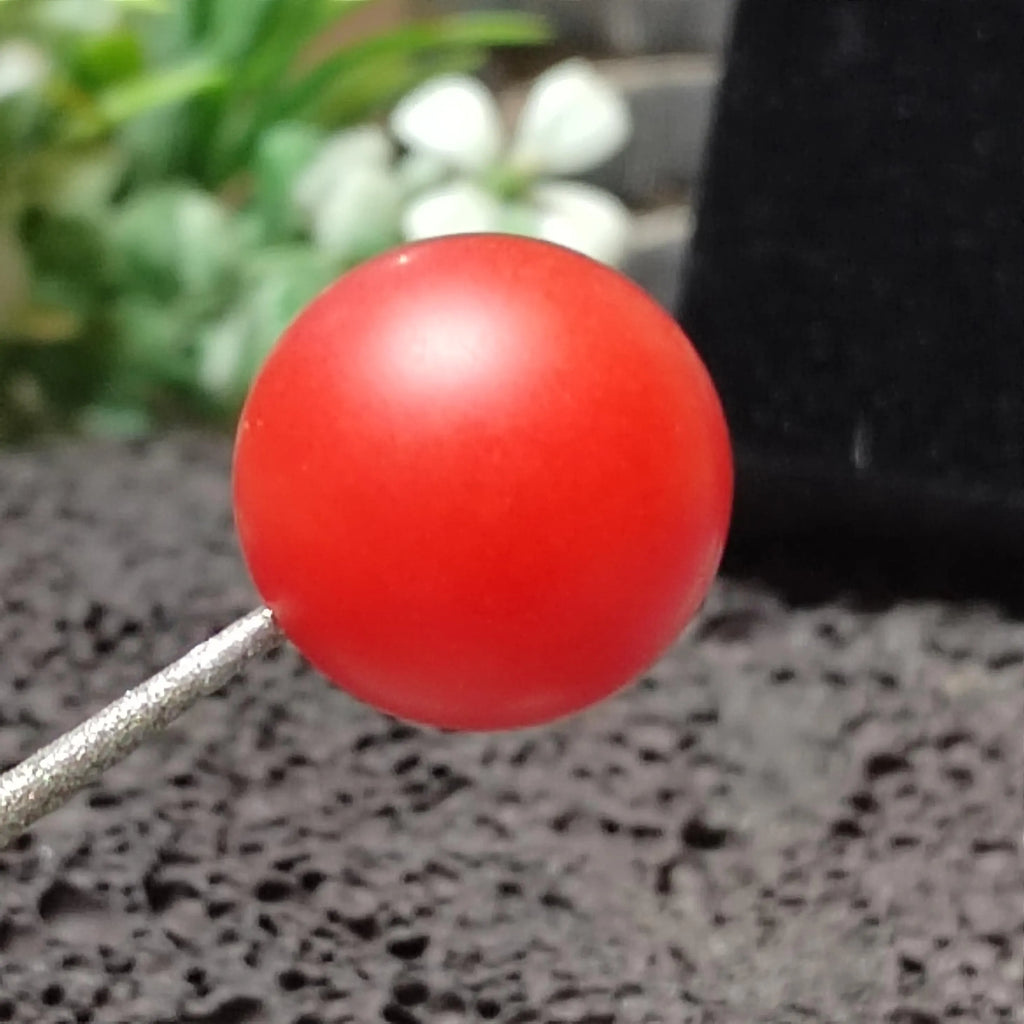 Red Nanhong bead on a stick with a blurred background