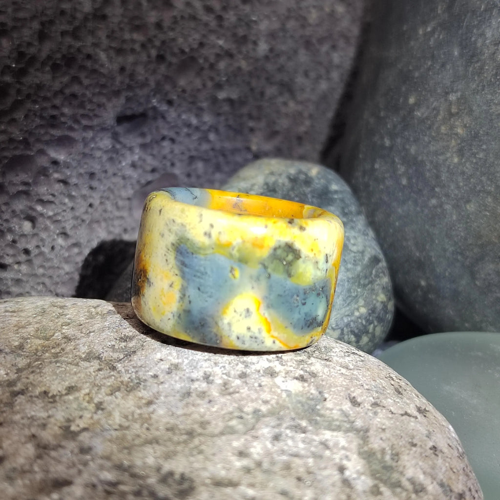 Marbled stone ring on a textured stone surface