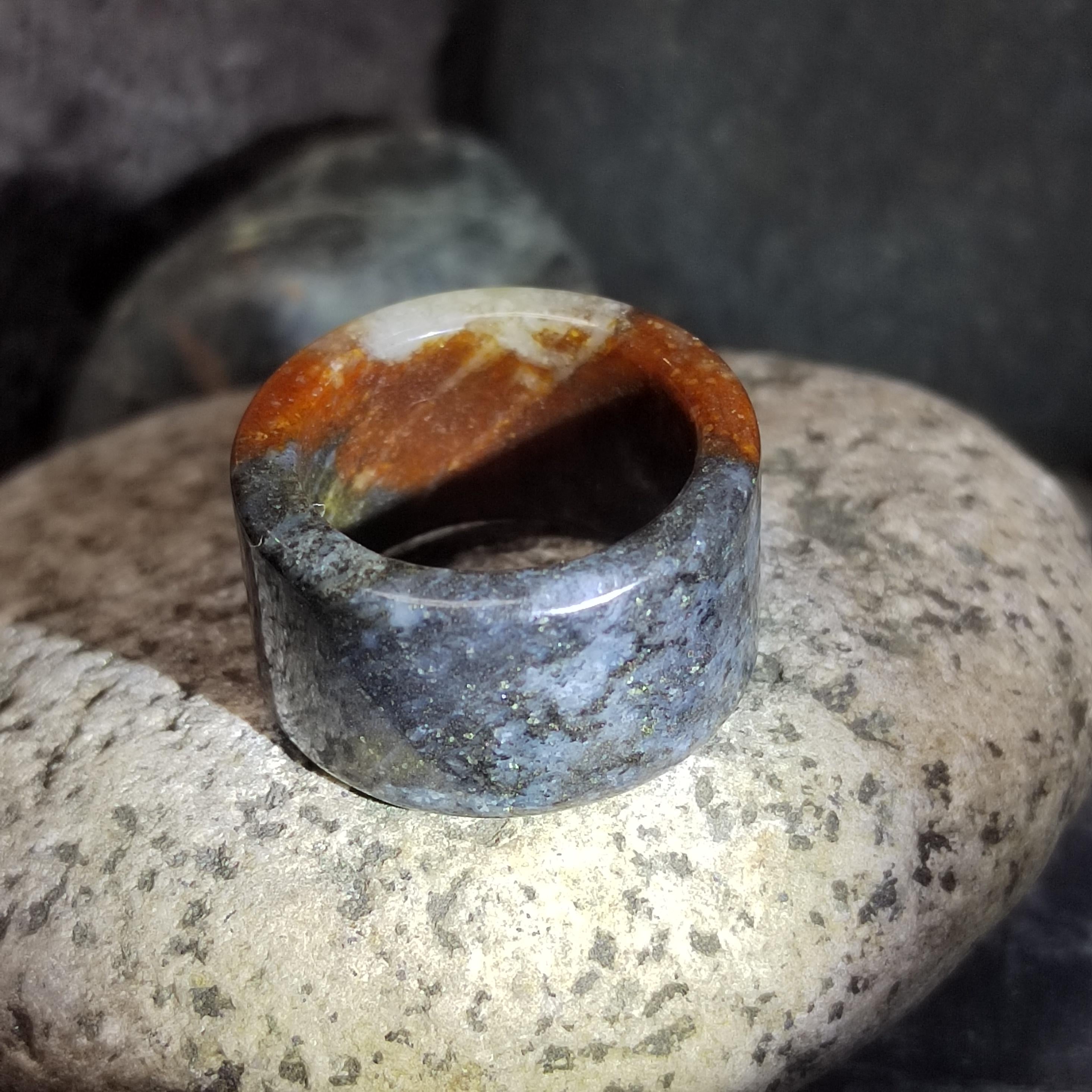 Natural stone ring with a unique color pattern on a rock surface