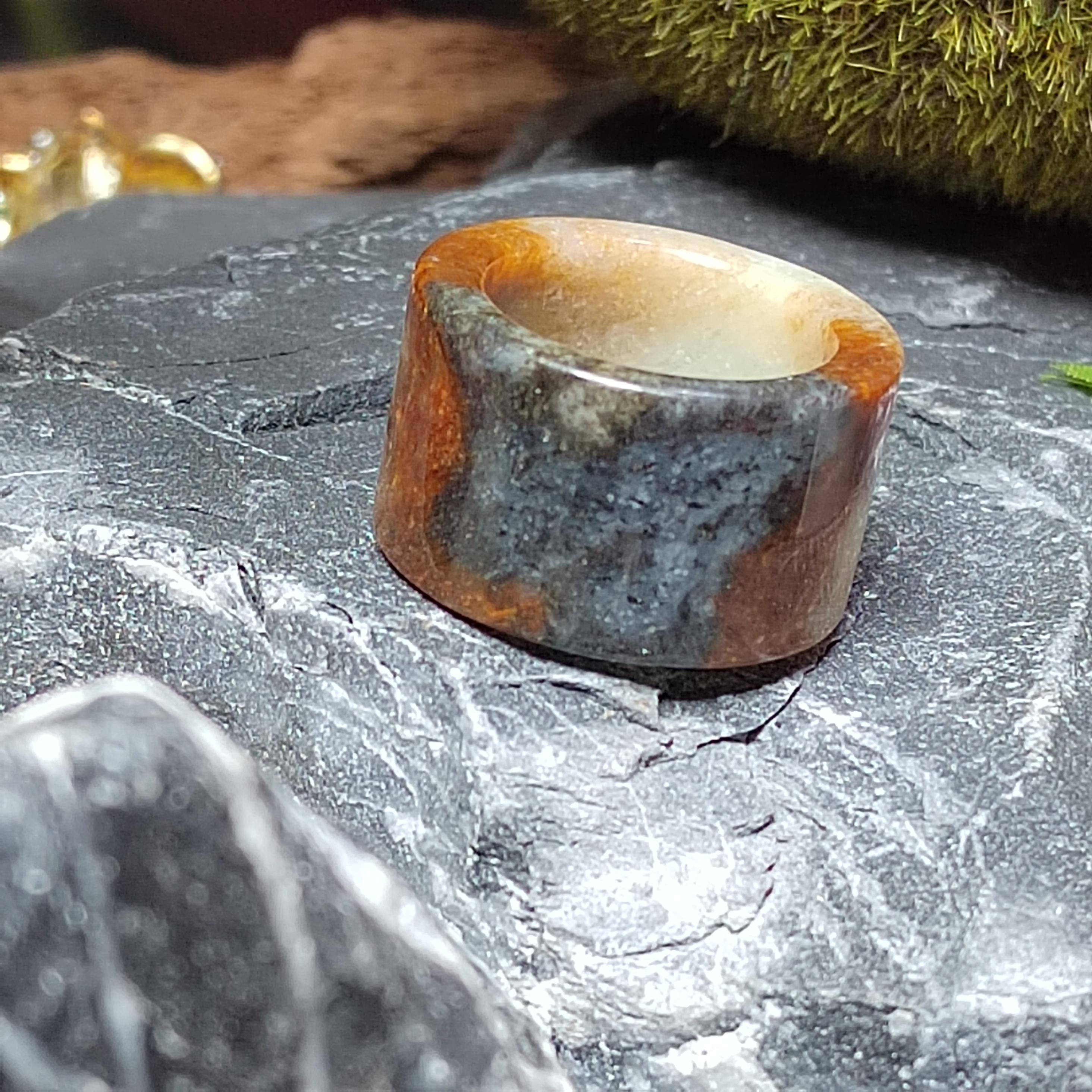 Stone ring with a natural pattern on a textured surface