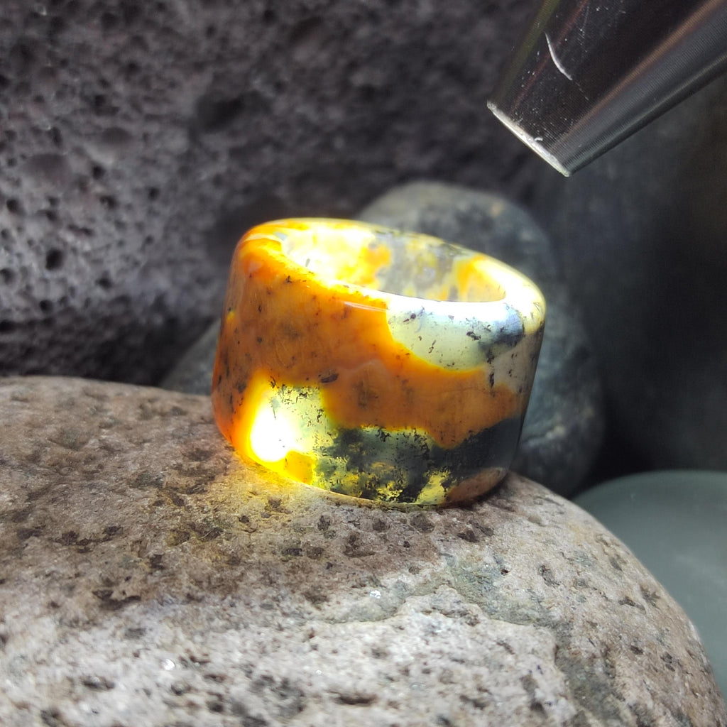 Amber stone with a knife blade on a rock
