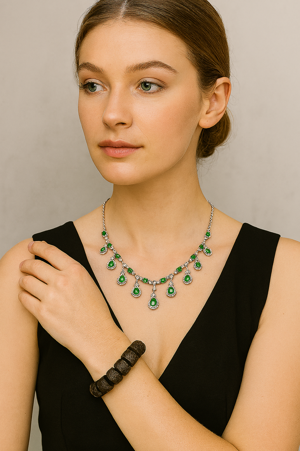 Woman wearing a green emerald necklace with a neutral background