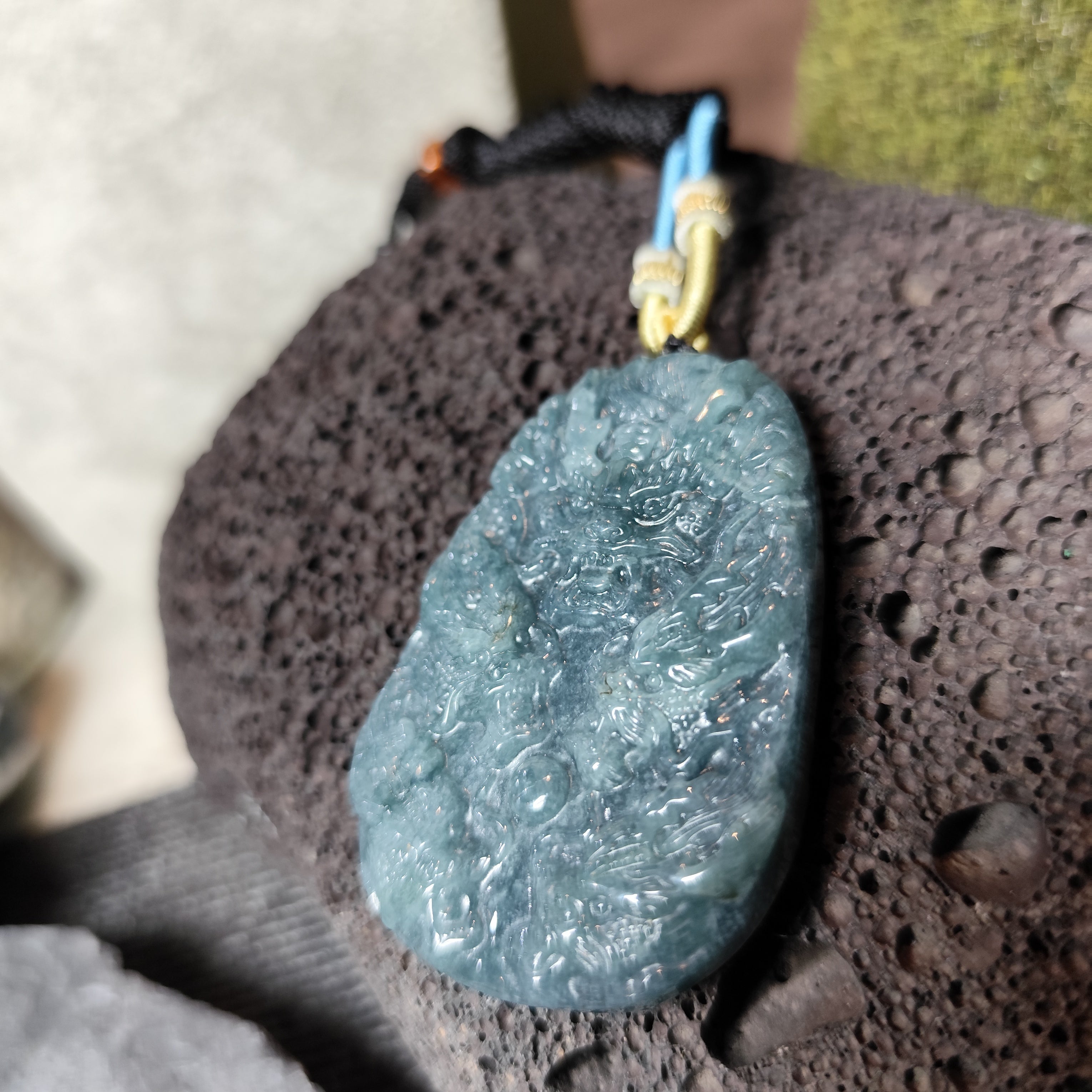 Blue stone pendant on a textured surface