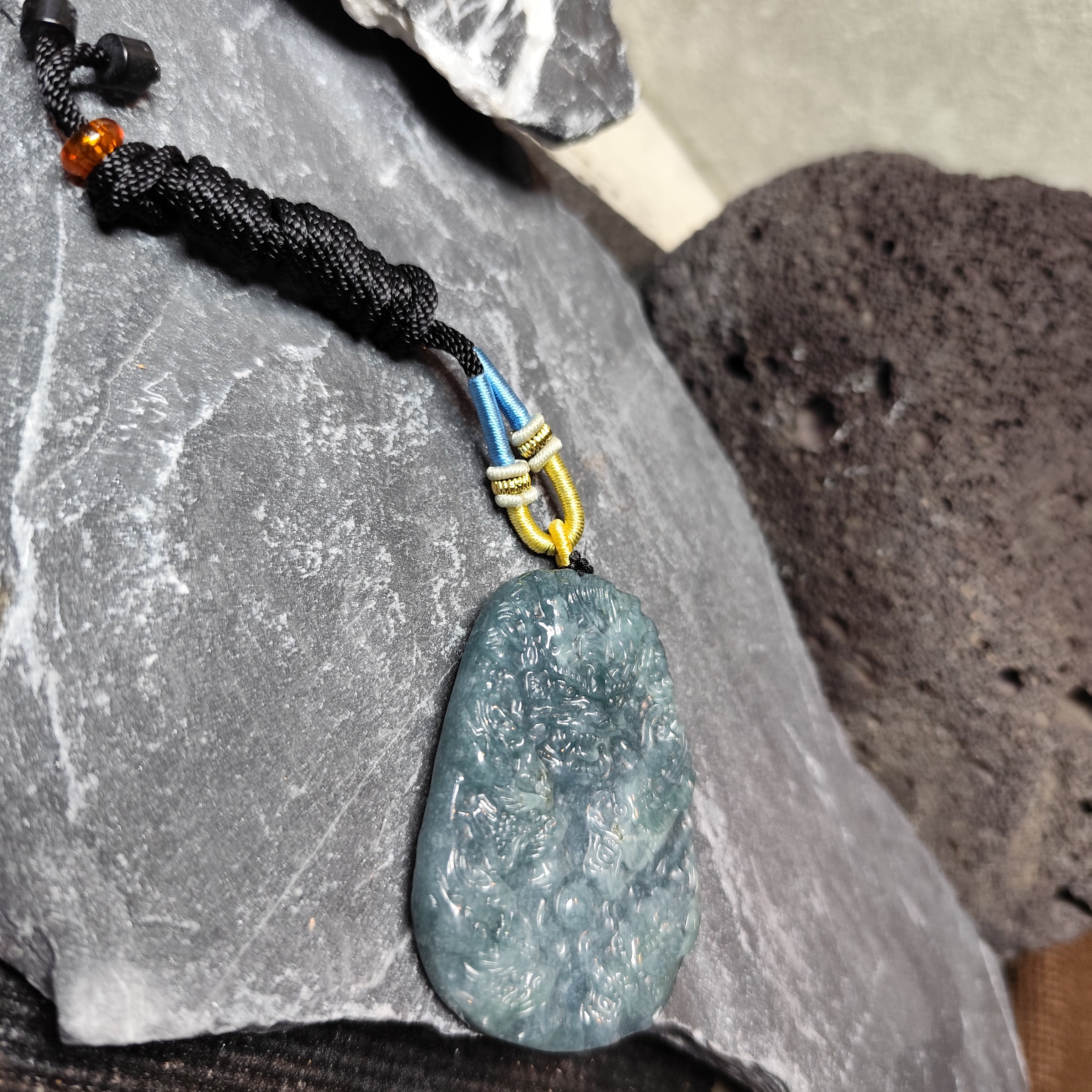 Necklace with a textured pendant on a stone surface